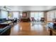 Comfortable living room with hardwood floors, sheer curtains, and ample natural light through expansive windows at 16 Golfview Ne Cir, Winter Haven, FL 33881