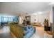 Spacious living room with a cozy fireplace, hardwood floors and an attached bedroom at 16 Golfview Ne Cir, Winter Haven, FL 33881