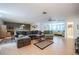 Open-concept living room with plush seating, hardwood floors, and an adjacent bedroom at 16 Golfview Ne Cir, Winter Haven, FL 33881