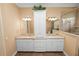 Bathroom featuring dual sinks, granite counters, and a glass-enclosed shower at 1772 Laurel Glen Pl, Lakeland, FL 33803