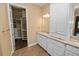 Bathroom featuring dual vanities, granite counters, and a walk-in closet at 1772 Laurel Glen Pl, Lakeland, FL 33803
