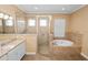 Bathroom featuring a glass-enclosed shower and a tiled tub with granite counters at 1772 Laurel Glen Pl, Lakeland, FL 33803