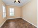 Empty bedroom showcasing tile flooring, neutral paint, crown molding, and shuttered windows at 1772 Laurel Glen Pl, Lakeland, FL 33803