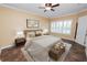 Staged bedroom with a comfortable bed, lamps, and a window with plantation shutters at 1772 Laurel Glen Pl, Lakeland, FL 33803