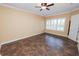 Bright bedroom with ceiling fan, tile floors, and window with plantation shutters at 1772 Laurel Glen Pl, Lakeland, FL 33803
