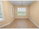 Dining area with views of the yard and large windows, complemented by a modern chandelier at 1772 Laurel Glen Pl, Lakeland, FL 33803