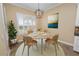 Cozy dining area with modern chandelier, complemented by a view of the yard through plantation shutters at 1772 Laurel Glen Pl, Lakeland, FL 33803