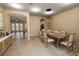 Dining area with a rustic wood table set for a meal, opening to living area at 1772 Laurel Glen Pl, Lakeland, FL 33803