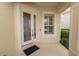 Elegant front entrance featuring a glass door and surrounding landscaping at 1772 Laurel Glen Pl, Lakeland, FL 33803