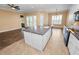 Kitchen features a granite island countertop with a sink and stainless steel appliances, all with white cabinets at 1772 Laurel Glen Pl, Lakeland, FL 33803