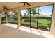 Screened lanai with lush landscaping views, ceiling fans and an entry door to the yard at 1772 Laurel Glen Pl, Lakeland, FL 33803