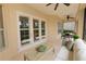 Screened lanai featuring ceiling fans, patio furniture, and access to the landscaped yard at 1772 Laurel Glen Pl, Lakeland, FL 33803