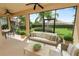 Comfortable screened lanai with ceiling fans, patio furniture and a view of the manicured backyard at 1772 Laurel Glen Pl, Lakeland, FL 33803