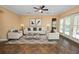 Bright living room boasts tile flooring, a ceiling fan, neutral walls, and comfortable seating perfect for relaxation at 1772 Laurel Glen Pl, Lakeland, FL 33803