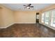 Open living room with large tile floors, ceiling fan, and natural light from french doors at 1772 Laurel Glen Pl, Lakeland, FL 33803