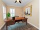 Home office with rich wood desk, shuttered windows, decor and stylish tile flooring at 1772 Laurel Glen Pl, Lakeland, FL 33803