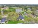 Stunning aerial view of a lakefront home with mature trees and a well-maintained yard, showcasing its desirable location at 1837 Farrington Dr, Lakeland, FL 33809