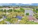 Scenic aerial shot of a lakeside house with a dark roof, nestled among mature trees, highlighting its tranquil location at 1837 Farrington Dr, Lakeland, FL 33809