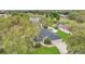 Aerial view of the house with a dark roof, surrounded by greenery and mature trees, showcasing its serene setting at 1837 Farrington Dr, Lakeland, FL 33809