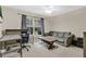 Cozy bedroom featuring a gray sofa, workspace, and large windows for natural light at 1837 Farrington Dr, Lakeland, FL 33809