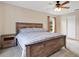 Bedroom featuring wood frame bed, side table and soft neutral decor at 1837 Farrington Dr, Lakeland, FL 33809