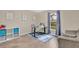 Bedroom with nice view from the window, blue accent rug, and cube storage at 1837 Farrington Dr, Lakeland, FL 33809