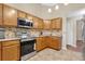 This open kitchen features stainless steel appliances and wooden cabinets at 1837 Farrington Dr, Lakeland, FL 33809