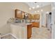 Well-lit kitchen featuring wooden cabinets, tile backsplash, and granite countertops at 1837 Farrington Dr, Lakeland, FL 33809