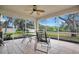 Enclosed patio with tiled floor, ceiling fan, and outdoor seating overlooking the backyard at 1837 Farrington Dr, Lakeland, FL 33809