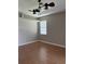 Neutral bedroom showcasing wood floors and a window for natural light at 200 S Goodman Ave, Lake Alfred, FL 33850