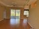 Spacious living area featuring sliding glass doors, opening to a screened lanai at 200 S Goodman Ave, Lake Alfred, FL 33850