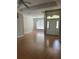 Open-concept living room featuring wood floors and a view into the dining area at 200 S Goodman Ave, Lake Alfred, FL 33850