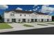 New townhome construction with neutral color scheme and attached parking at 206 Turtle Bay Ave, Winter Haven, FL 33881