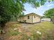 Backyard view of the home, showing a fenced yard and patio area at 209 W Crescent Dr, Lakeland, FL 33805