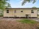 View of the rear exterior of the house with water heater and latticework foundation at 209 W Crescent Dr, Lakeland, FL 33805
