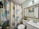 Bathroom featuring a vanity, mirror, and a patterned shower curtain at 209 W Crescent Dr, Lakeland, FL 33805