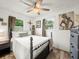 Cozy bedroom with wood floors, two windows, and neutral decor at 209 W Crescent Dr, Lakeland, FL 33805