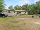 Inviting home exterior with lush front lawn, landscaping, and convenient storage shed at 209 W Crescent Dr, Lakeland, FL 33805