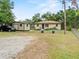 Quaint home with gravel drive and a storage shed, set on a spacious, partially shaded lot at 209 W Crescent Dr, Lakeland, FL 33805