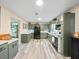 Charming kitchen featuring green cabinetry, modern appliances, and stylish countertops at 209 W Crescent Dr, Lakeland, FL 33805
