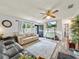 Bright living room featuring modern ceiling fan and hardwood flooring at 209 W Crescent Dr, Lakeland, FL 33805