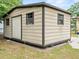 Durable metal storage shed offering ample space, complemented by surrounding greenery at 209 W Crescent Dr, Lakeland, FL 33805