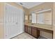 Neutral-toned bathroom with ample counter space and large mirror at 2173 Castle Pt, Winter Haven, FL 33880
