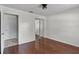 Bedroom view features hardwood floors, mirrored closet doors and a ceiling fan with light at 2173 Castle Pt, Winter Haven, FL 33880