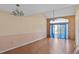 Bright living room with ceiling fan, hardwood floors, and large windows at 2173 Castle Pt, Winter Haven, FL 33880