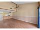 Open living space with hardwood floors, ceiling fan, and ample natural light at 2173 Castle Pt, Winter Haven, FL 33880