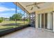 Relaxing screened patio features tiled flooring, ceiling fan, and great view of the community at 2173 Castle Pt, Winter Haven, FL 33880