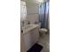 Standard bathroom featuring a vanity with sink and toilet with a blue striped shower curtain at 220 Pinehurst Dr, Auburndale, FL 33823