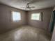 Standard bedroom with two windows and ceiling fan at 220 Pinehurst Dr, Auburndale, FL 33823