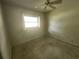 Cozy bedroom with ceiling fan and window allowing natural light at 220 Pinehurst Dr, Auburndale, FL 33823